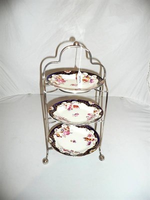 Lot 255 - A George V plated three tier cake stand with three Staffordshire porcelain plates