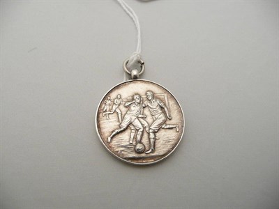 Lot 256 - A George V silver Chester football pendant engraved with football scenes 1925