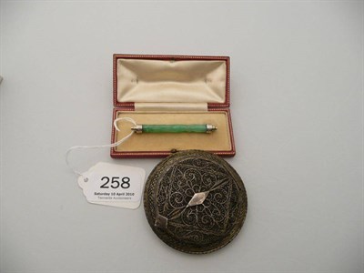 Lot 258 - A 9 carat white gold and jade bar brooch, an Indian silver filigree powder compact (2)