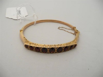 Lot 307 - A 9 carat gold garnet and diamond bangle, 7.8g approx. (a.f.)