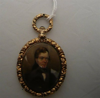 Lot 309 - A miniature locket in a carved frame