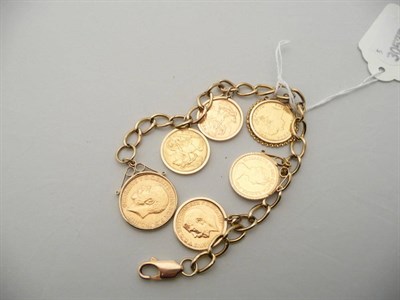 Lot 319 - A 9 carat gold curb-link bracelet hung with a 1927 full sovereign, a 1914 half sovereign, two...