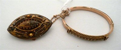 Lot 321 - A 9 carat gold Victorian bangle and a Victorian brooch with locket panel