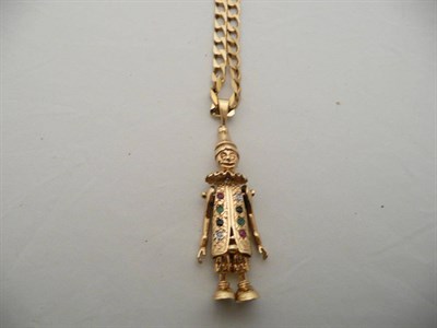 Lot 322 - A 9 carat gold gem set clown pendant on a 9 carat gold curb necklace, 33.5g approximately