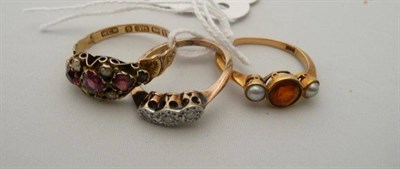 Lot 326 - A diamond three stone ring, a 9 carat gold garnet and seed pearl ring (a.f.) and a dress ring