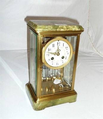 Lot 351 - A gilt brass and onyx striking four glass mantel clock with twin mercury compensating pendulum...