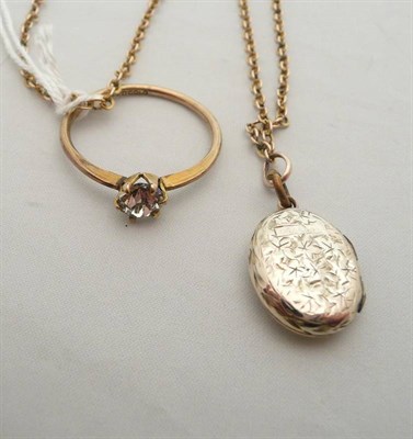 Lot 471 - A locket on chain and a paste set dress ring