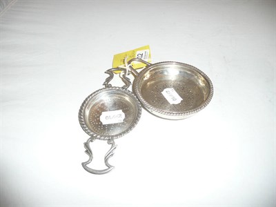 Lot 512 - Georgian silver lemon strainer and a plated tea strainer (2)