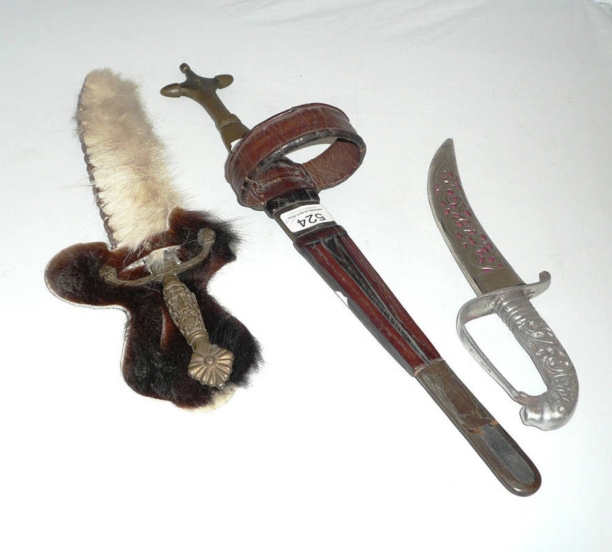 Lot 524 - A Somali arm dagger and two other daggers, one Indian