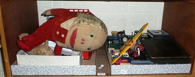 Lot 527 - A shelf of toys including Merrythought Humpty Dumpty, tinplate toys, Matchbox and other diecast and