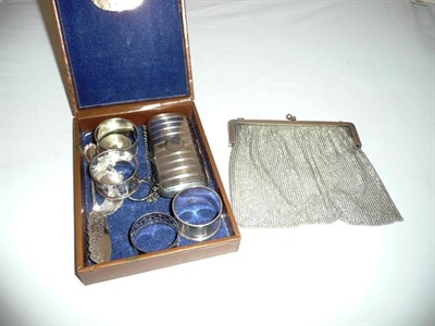 Lot 538 - A silver plated reticule, silver purse, four napkin rings, a pair of decanter labels, a butter...