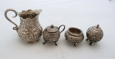 Lot 542 - Indian silver three piece condiment set and a cream jug