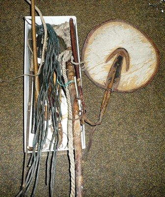 Lot 563 - Four fly whisks, an African hide fan, an African woven vegetable fibre and leather 'flag',...