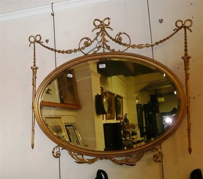 Lot 621 - Gilt oval ribbon wall mirror