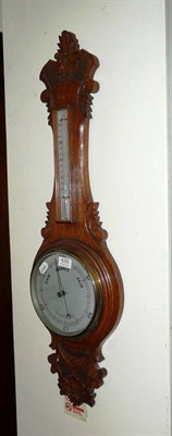 Lot 630 - A Victorian Aneroid barometer in an oak banjo case