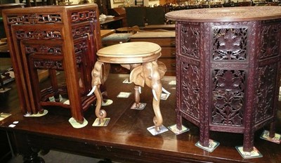 Lot 649 - A Burmese carved hardwood occasional table on folding stand, an occasional table on elephant...