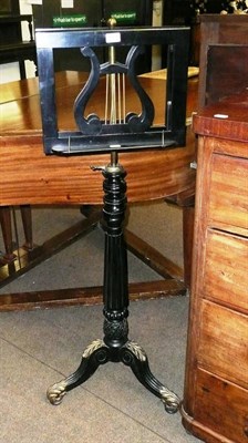 Lot 653 - An Ebonised and Parcel Gilt Adjustable Duet Stand, with turned, reeded and foliate carved...