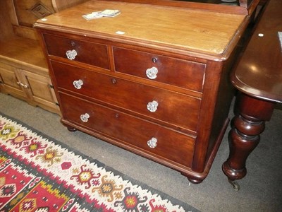 Lot 664 - A Victorian mahogany small three height chest with moulded handles