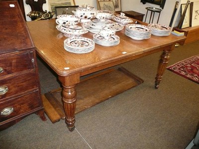 Lot 676 - Late Victorian oak wind-out table with two extra leaves and winder