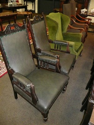 Lot 678 - A green upholstered wing back chair and a pair of ebonised open arms chairs