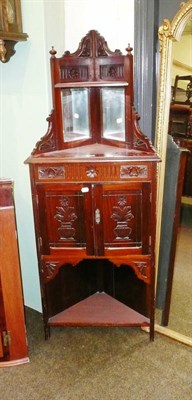 Lot 720 - A late Victorian carved walnut corner cupboard