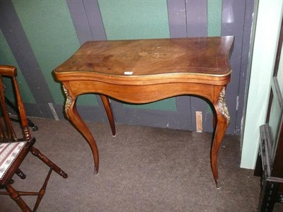 Lot 730 - A Victorian floral marquetry card table, circa 1880, the serpentine and brass edged hinged top...