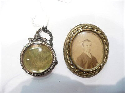 Lot 61 - A circular paste locket, stamped 925 with chain and a swivel centre locket brooch and a 9ct...