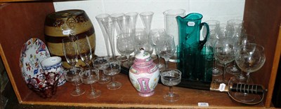 Lot 106 - Shelf including etched glasses, champagne glasses, stoneware barrels, sword, a green glass lemonade