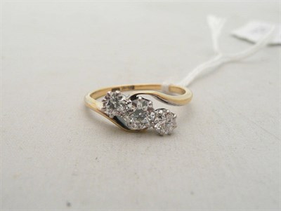 Lot 251 - A diamond three stone twist ring