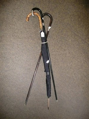 Lot 276 - Two silver mounted walking sticks, a gold plate mounted umbrella