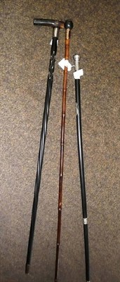 Lot 277 - An African ebony waling stick, a silver mounted walking stick and a bamboo walking stick with...