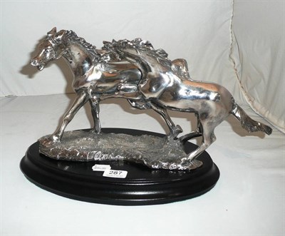 Lot 287 - A silver filled figure of two horses