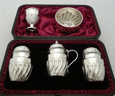 Lot 304 - A three piece cased cruet set, an egg cup and a sugar