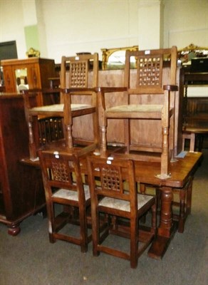 Lot 390 - An oak dining table, set of six lattice back dining chairs including two carvers