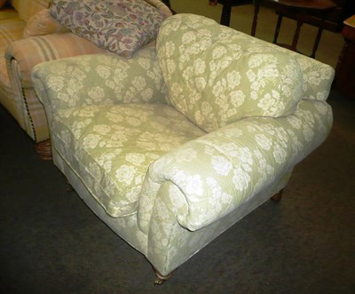 Lot 423 - A modern pine-framed armchair upholstered in floral fabric