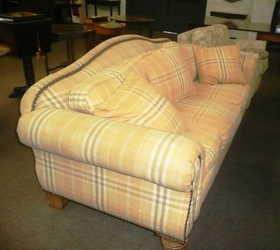 Lot 424 - A modern pine-framed three-seater settee upholstered in yellow