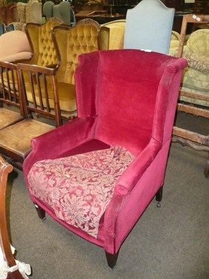 Lot 427 - A late 19th century wing back chair