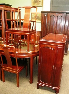 Lot 477 - A Chinese hardwood extending dining table, eight chairs including two carvers and a cocktail...