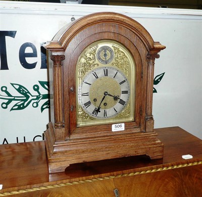 Lot 506 - A Victorian oak mantel clock with key and pendulum (in back of clock)