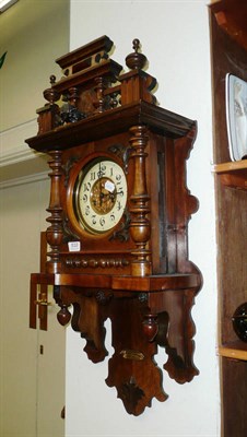 Lot 510 - A Continental walnut cased wall clock