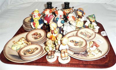 Lot 14 - A tray of Hummel and Goebel figures and plates and a display stand