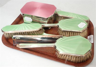 Lot 22 - A pink enamelled silver box and a silver and green enamelled six piece brush set