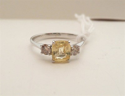 Lot 68 - A 14ct white gold yellow sapphire and diamond ring