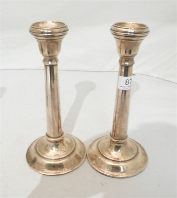 Lot 87 - A pair of loaded silver candlesticks