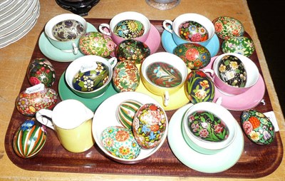 Lot 179 - Twenty one painted eggs, seven Worcester Harlequin cups and saucers, cream and sugar