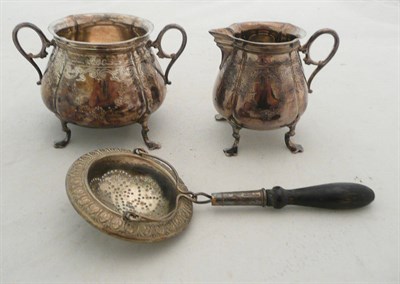 Lot 195 - A Victorian silver cream jug and sugar basin and a plated tea strainer