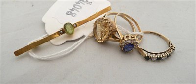 Lot 200 - A 9ct gold and peridot bar brooch, a citrine-set dress ring and two other dress rings