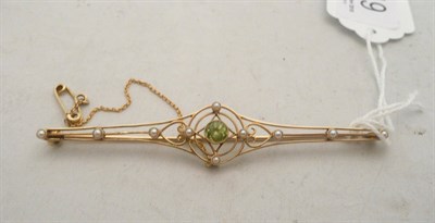 Lot 219 - A peridot and seed pearl bar brooch