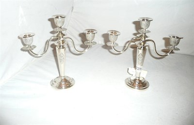 Lot 228 - A pair of white metal candlesticks