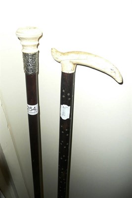 Lot 254 - Two walking sticks with ivory handles
